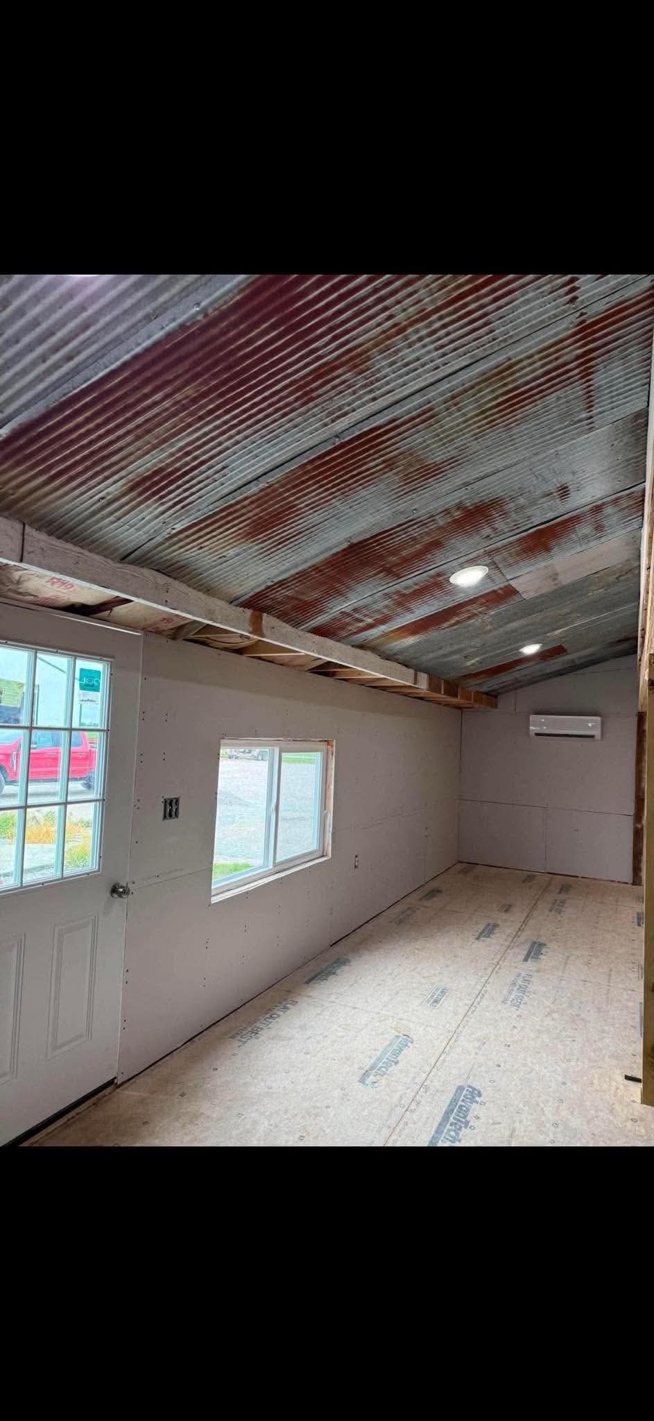 Room addition interior with new window and subfloor by AMC Construction