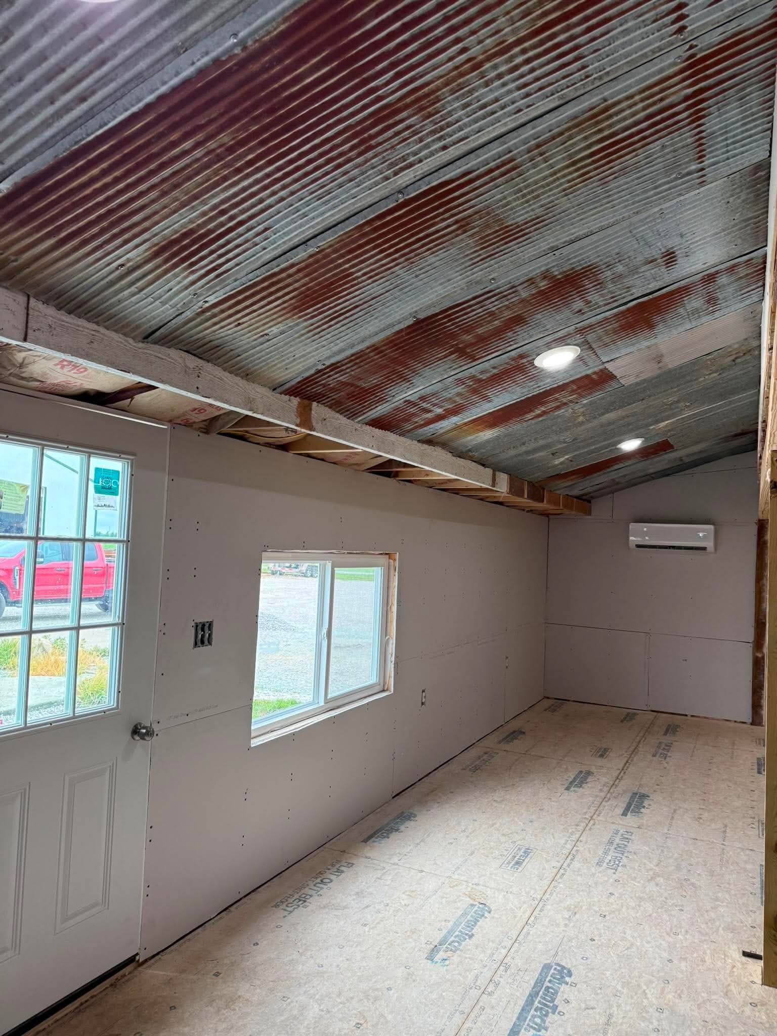 Room addition with new drywall, door and window by AMC Construction