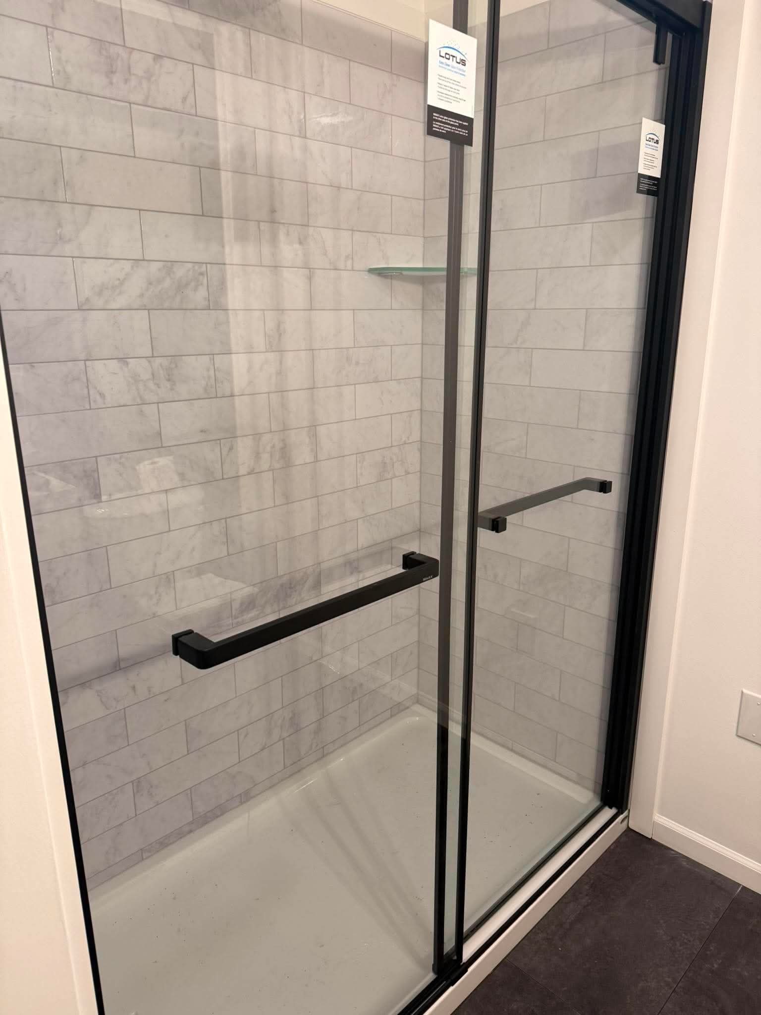 Marble subway tile shower with frameless glass door