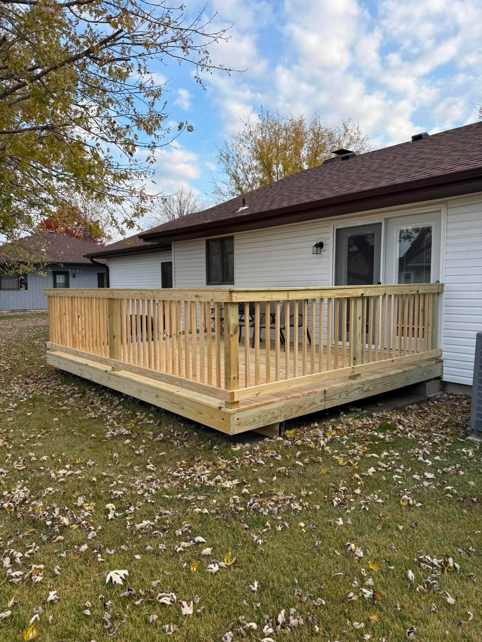 New pressure-treated wood deck with railing