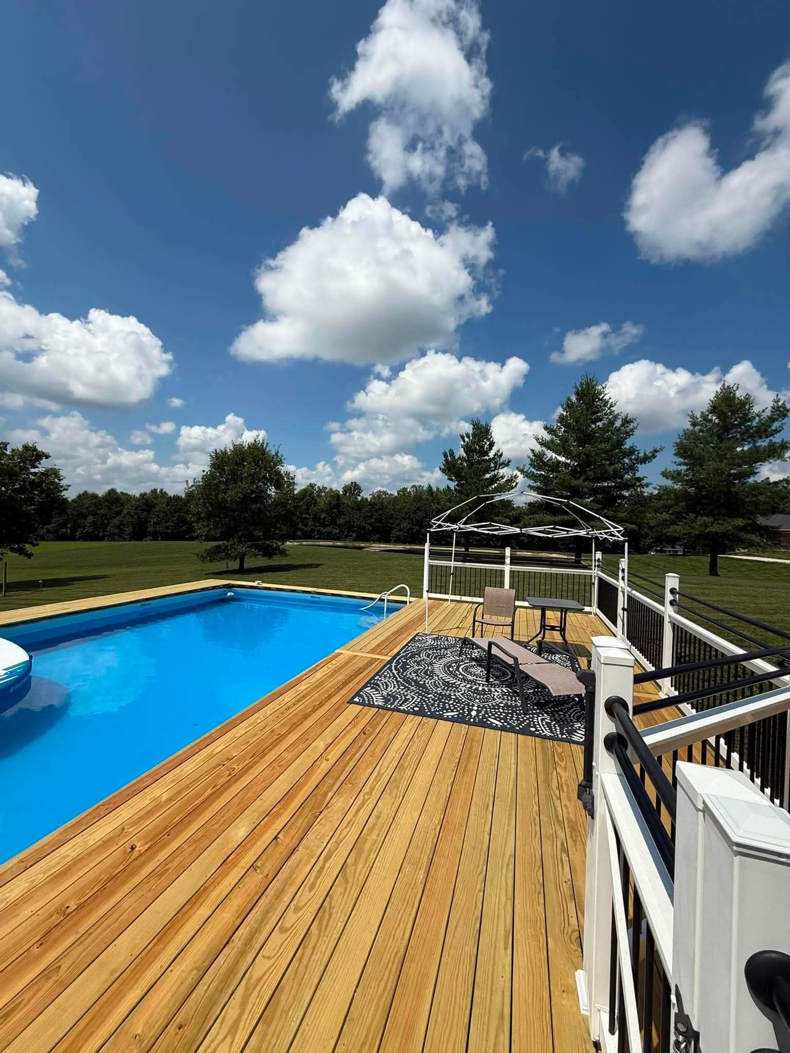 Wood pool deck beside an above-ground pool