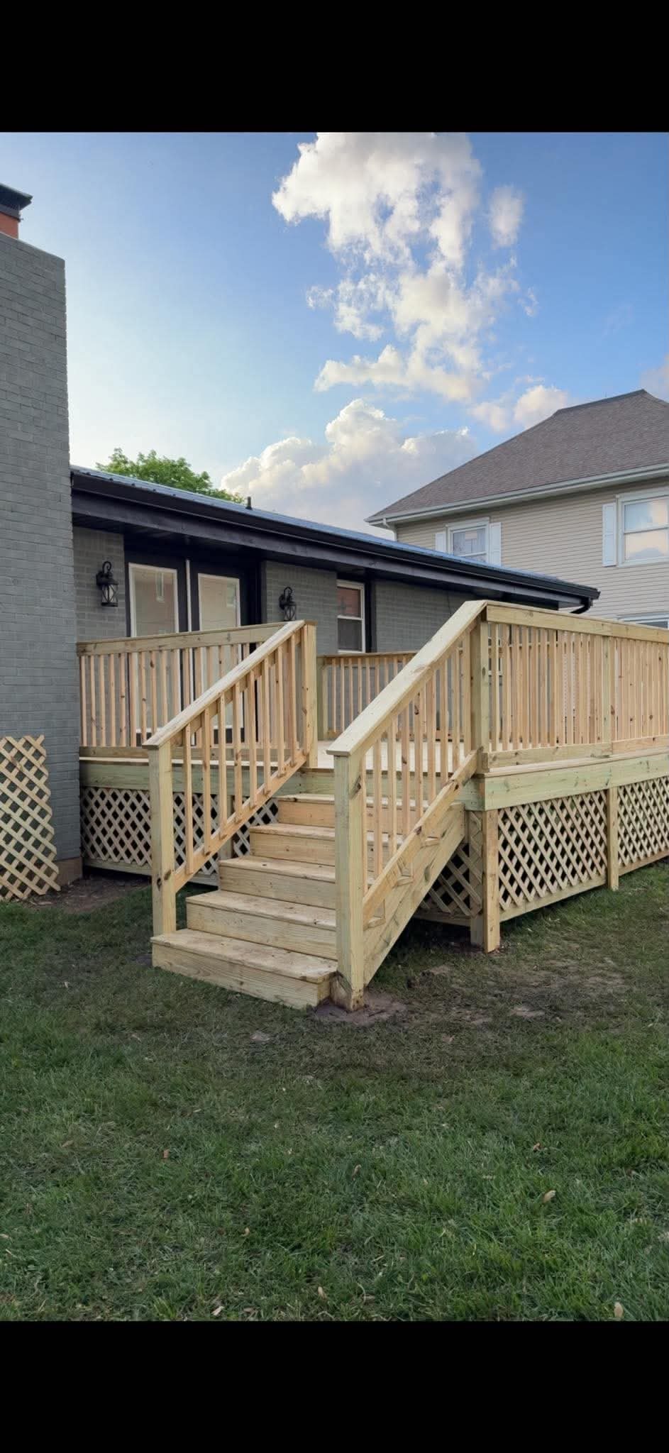 Raised wood deck with stairs and lattice skirting