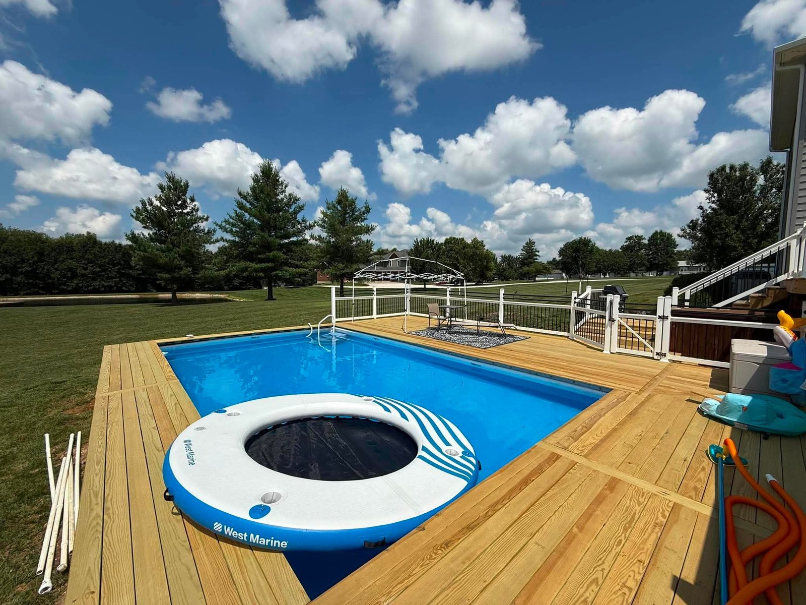 Wraparound wood deck around an in-ground pool