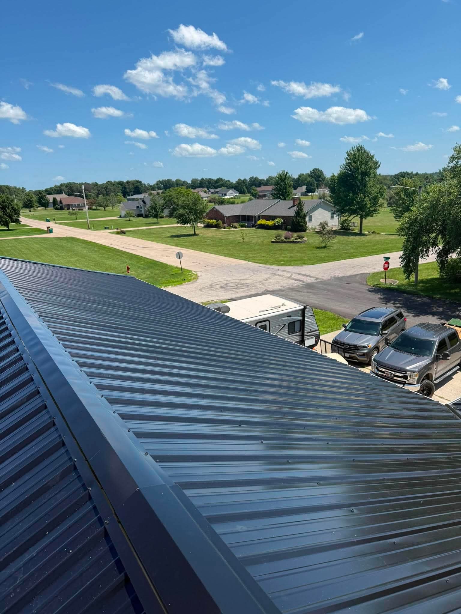 New metal roof panels overlooking a neighborhood